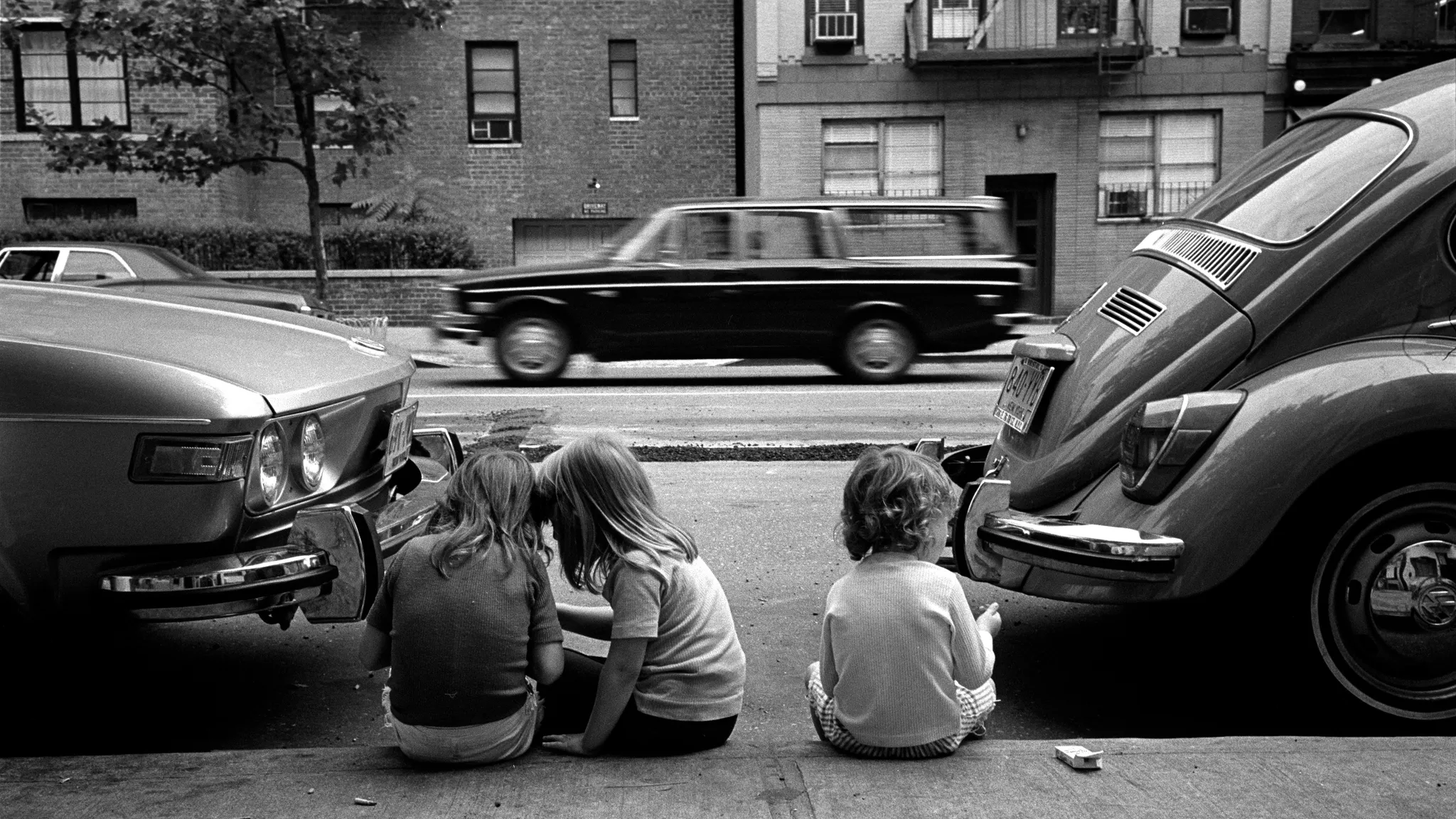 Children sitting on a Manhattan sidewalk, 1973