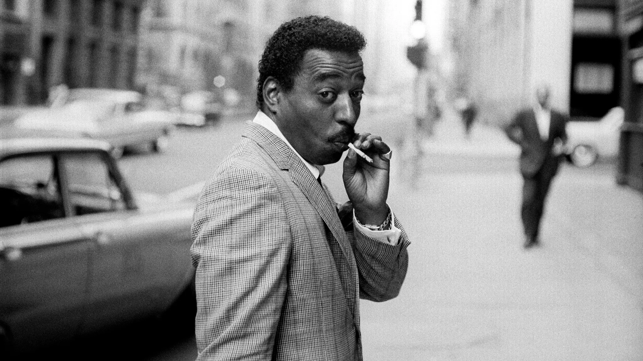 Jazz drummer Chico Hamilton walking in Manhattan, 1962
